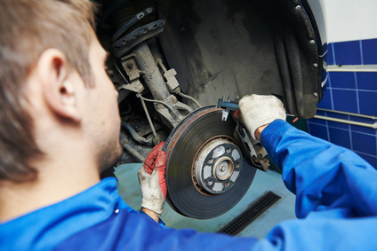Technician removing a brake disc. 